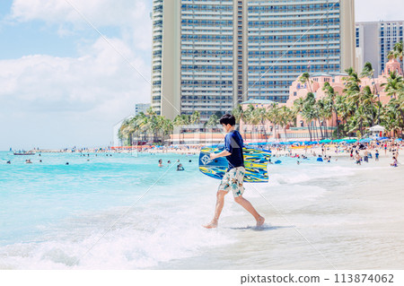 Man running towards the ocean on Waikiki Beach, Hawaii Man running towards the ocean on Waikiki Beach, Hawaii 113874062