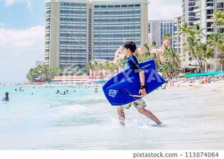 Man running towards the ocean on Waikiki Beach, Hawaii Man running towards the ocean on Waikiki Beach, Hawaii 113874064