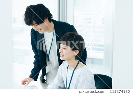 Office worker facing a computer Office worker facing a computer 113874180