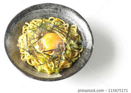 Aerial view of hot oil soba noodles topped with egg yolk, shredded seaweed, and green onions, shot on a white background 113875171