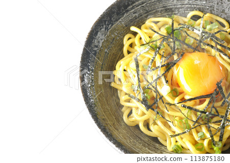 Aerial view of hot oil soba noodles topped with egg yolk, shredded seaweed, and green onions, shot on a white background 113875180