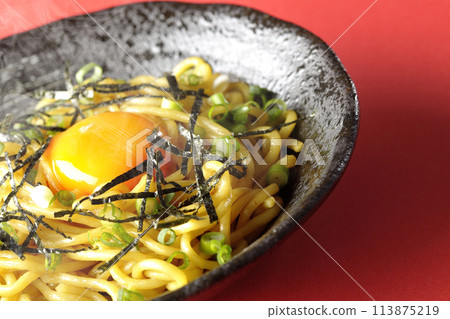 Hot oil soba noodles topped with egg yolk, shredded seaweed, and spring onions Hot oil soba noodles topped with egg yolk, shredded seaweed, and spring onions 113875219