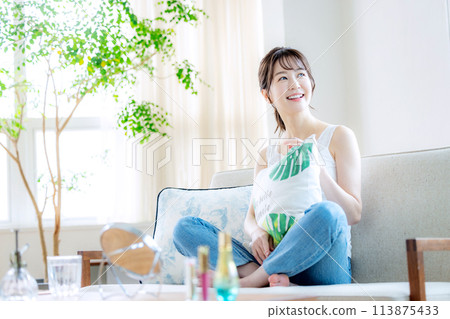 Woman relaxing at home Woman relaxing at home 113875433