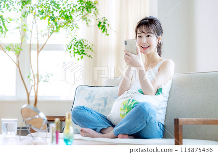 Female living alone smartphone Female living alone smartphone 113875436