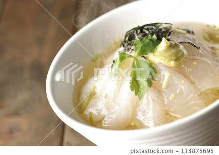Hot sea bream chazuke with hot dashi broth and topped with mitsuba, shredded seaweed, and wasabi 113875695