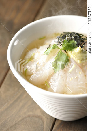 Hot sea bream chazuke with hot dashi broth and topped with mitsuba, shredded seaweed, and wasabi Hot sea bream chazuke with hot dashi broth and topped with mitsuba, shredded seaweed, and wasabi 113875704