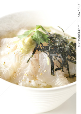 Hot sea bream chazuke with dashi broth, topped with mitsuba, shredded seaweed, and wasabi, photographed on a white background Hot sea bream chazuke with dashi broth, topped with mitsuba, shredded seaweed, and wasabi, photographed on a white background 113875827