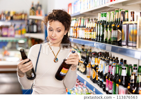 Adult woman choosing beer in store 113876563