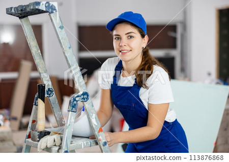 Woman foreman signs an act of acceptance of completed work Woman foreman signs an act of acceptance of completed work 113876868
