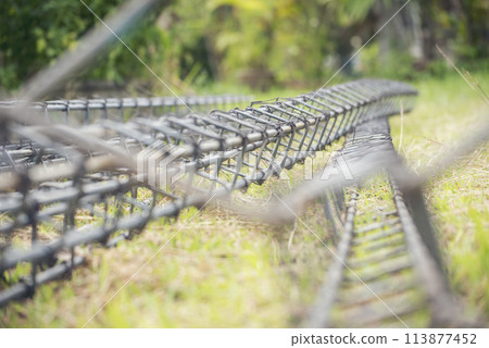 Iron wire reinforcement of concrete work. Construction site objects of bending cutting stainless steel wire fences bar. Civil construction engineering concept. pile of under construction materials Iron wire reinforcement of concrete work. Construction site objects of bending cutting stainless steel wire fences bar. Civil construction engineering concept. pile of under construction materials 113877452