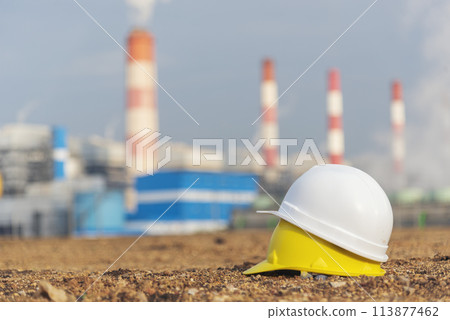 Worker Hard hat at Power stations manufacturing electrical industrial plant. Construction hard hat safety helmet Electric power building refinery engineering safety tools Lignite electricity chimneys 113877462
