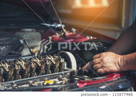 Close up Man hands fixing Car machinery vehicle mechanical service. Mechanic man hands repairing car auto repair shop. open vehicle hood checking up auto mobile. Vehicle Car maintenance engineer. 113877466