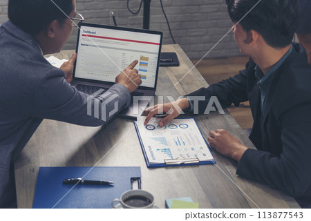 Happiness two businessman working together confident team meeting in office desk. Team business man partners working with laptop startup company. Asian man colleague friendship at work staff meeting Happiness two businessman working together confident team meeting in office desk. Team business man partners working with laptop startup company. Asian man colleague friendship at work staff meeting 113877543