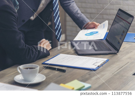 Happiness two businessman working together confident team meeting in office desk. Team business man partners working with laptop startup company. Asian man colleague friendship at work staff meeting Happiness two businessman working together confident team meeting in office desk. Team business man partners working with laptop startup company. Asian man colleague friendship at work staff meeting 113877556