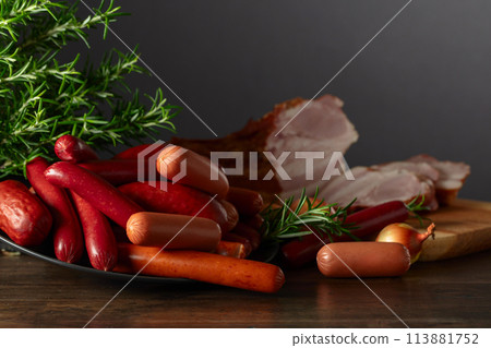 Various sausages and smoked pork on a kitchen table. Various sausages and smoked pork on a kitchen table. 113881752