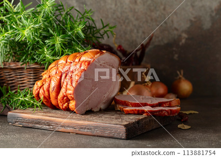 Smoked pork ham on a kitchen table. Smoked pork ham on a kitchen table. 113881754