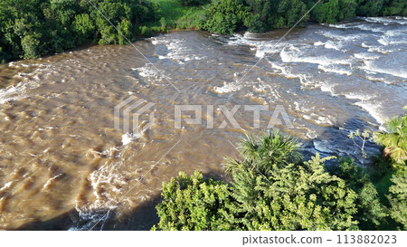 apore river with brown water and riparian forest during the day 113882023