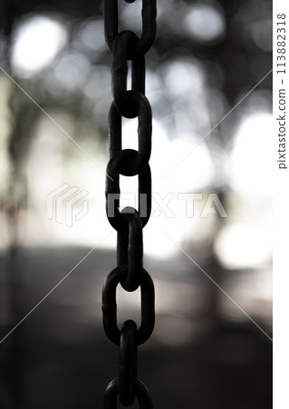 steel chain suspended in close up steel chain suspended in close up 113882318