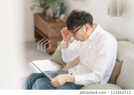 A man holding his eyes A man holding his eyes 113882511