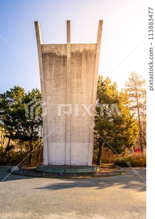 The Berlin Airlift Memorial bathed in the warm glow of a sunrise, with the Tempelhof Airport terminal in the background. The Berlin Airlift Memorial bathed in the warm glow of a sunrise, with the Tempelhof Airport terminal in the background. 113883477
