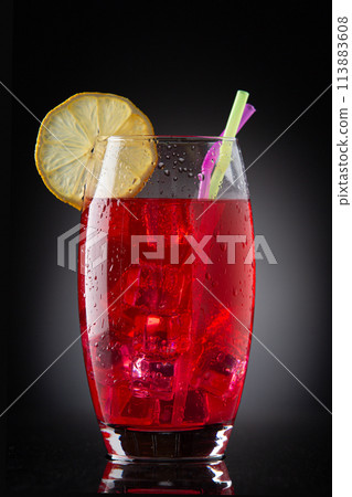 glass with red drink with ice 113883608