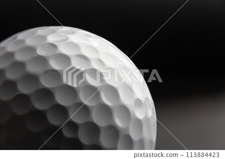 golf ball seen very close. Black background golf ball seen very close. Black background 113884423