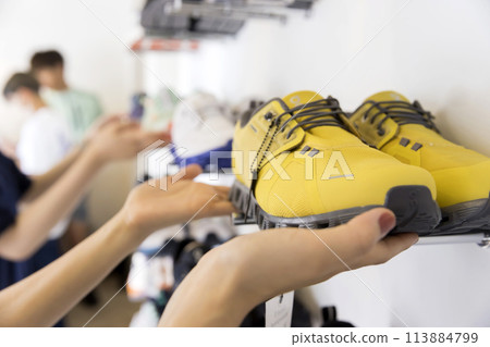 Young woman shopping at a shoe shop or preparing to open 113884799