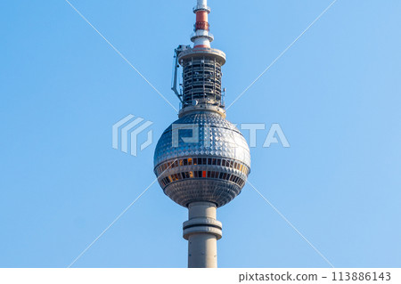 Close-up view of Berlins TV Tower showcasing its spherical observation deck against a clear sky. Berlin, Germany 113886143