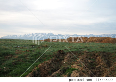 The Tatra Mountains are the highest part of the Carpathians, located in Slovakia and Poland, part of the Fatrans-Tatrans region. View from afar. Field, arable land 113886822
