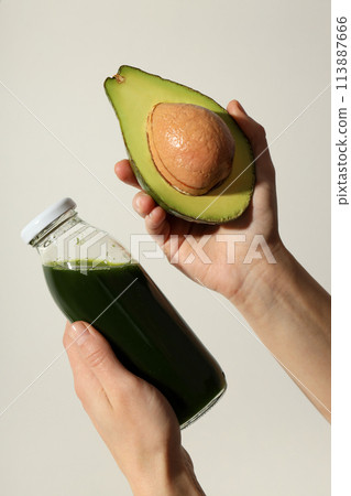 Smoothie with avocado on a light background Smoothie with avocado on a light background 113887666