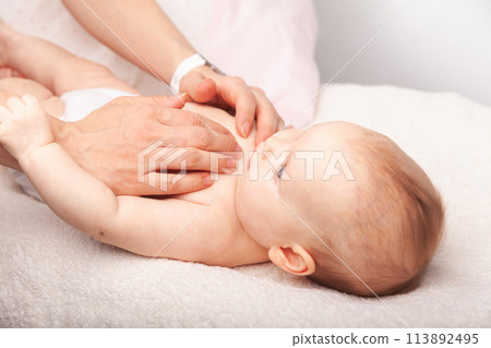 Little baby receiving chiropractic treatment of her chest Little baby receiving chiropractic treatment of her chest 113892495