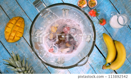 Overhead Shot of Pieces of Fruits with Milk in Blender. 113892542