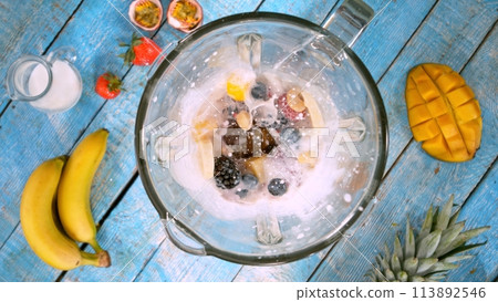 Overhead Shot of Pieces of Fruits with Milk in Blender. 113892546
