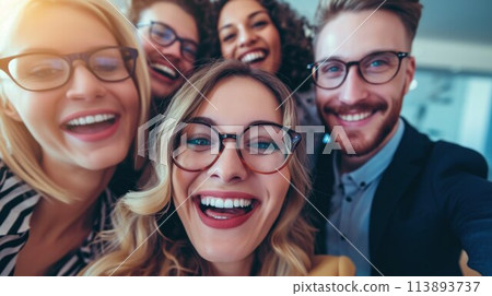 Multiracial group of cheerful business seminar attendees taking selfie in conference hall and looking at camera 113893737