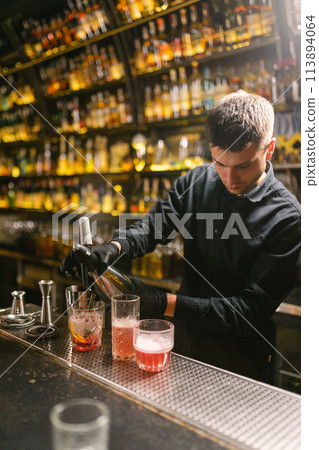 Bartender makes delicious cocktails in vintage night pub 113894064