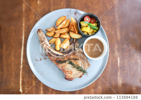 pork chop or grilled pork with French fries and salad pork chop or grilled pork with French fries and salad 113894188