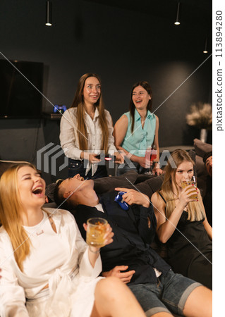 Laughing gaming enthusiasts engage in friendly competition Laughing gaming enthusiasts engage in friendly competition 113894280