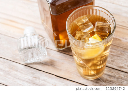 Highball, Whiskey with soda and lemon beverage on wooden table Highball, Whiskey with soda and lemon beverage on wooden table 113894742