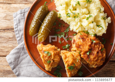 Czech holandsky rizek Schnitzel Breaded Pork served with mashed potatoes closeup on the plate. Horizontal top view Czech holandsky rizek Schnitzel Breaded Pork served with mashed potatoes closeup on the plate. Horizontal top view 113895677