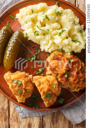 Ground Pork Cheese Schnitzel Czech Holandsky Rizek served with mashed potatoes closeup on the plate on the table. Vertical top view 113895680