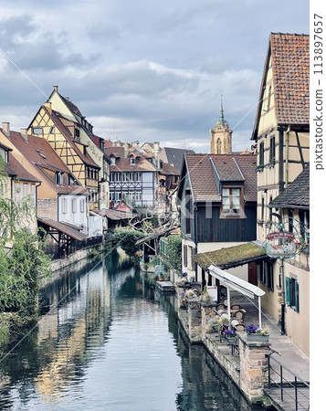 Urban medieval landscape of Alsace, water canal Colmar, France.  113897657