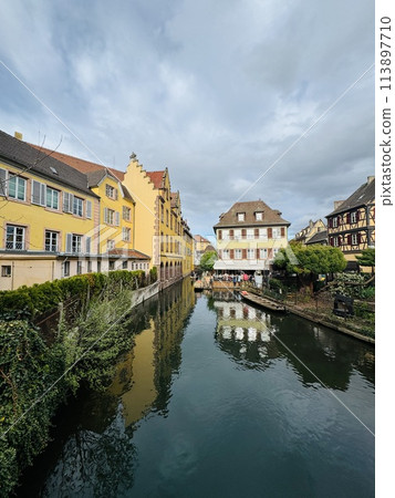 Urban medieval landscape of Alsace, water canal Colmar, France.  113897710