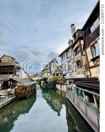 Urban medieval landscape of Alsace, water canal Colmar, France. Urban medieval landscape of Alsace, water canal Colmar, France. 113897733