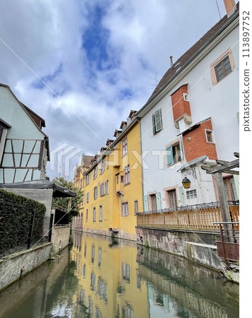 Urban medieval landscape of Alsace, water canal Colmar, France. Urban medieval landscape of Alsace, water canal Colmar, France. 113897752