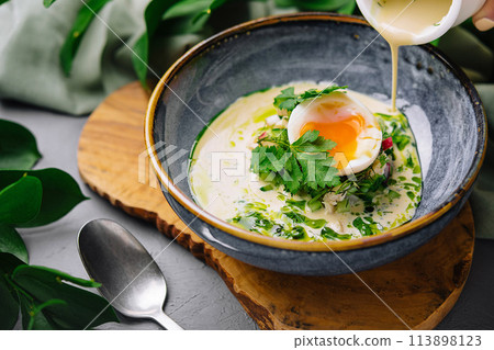 Gourmet poached egg breakfast bowl with hollandaise sauce 113898123