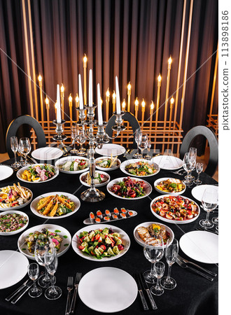 Elegant banquet table setting with candelabra 113898186