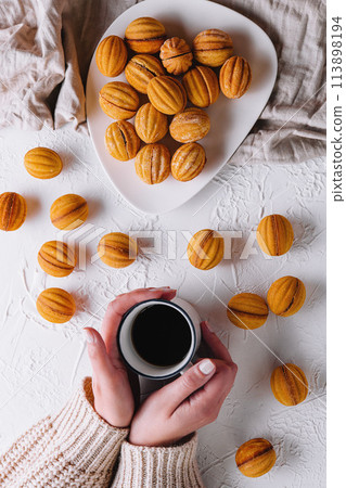 Cozy morning with coffee and walnut-shaped cookies 113898194