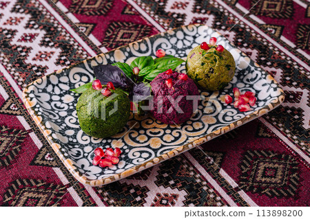 Colorful trio of gourmet vegan balls on decorative plate Colorful trio of gourmet vegan balls on decorative plate 113898200