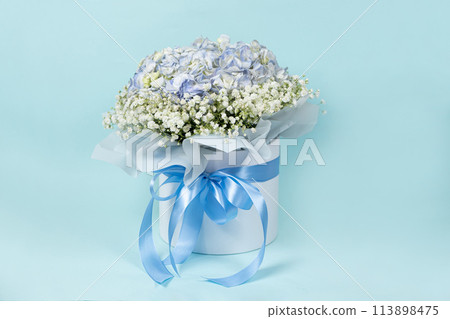 Bouquet of flowers made of hydrangeas and gypsophila in a white box with a bow Bouquet of flowers made of hydrangeas and gypsophila in a white box with a bow 113898475
