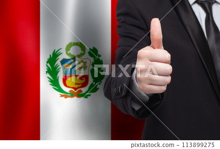 Peru concept. Businessman showing thumb up on the background of flag of Peru Peru concept. Businessman showing thumb up on the background of flag of Peru 113899275